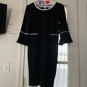 Never worn, black dress with white trim, flared sleeves.